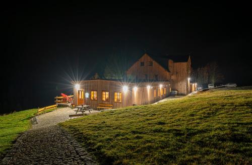 a building on a hill at night with lights at Horská bouda Krakonoš in Pec pod Sněžkou