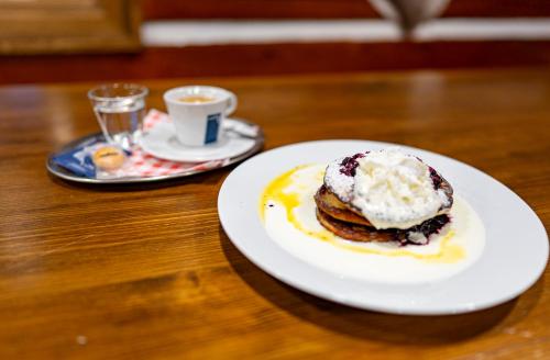 a plate of food on a table with a cup of coffee at Horská bouda Krakonoš in Pec pod Sněžkou