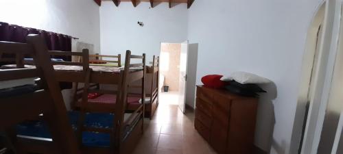 a room with two bunk beds and a hallway at Habitación Juvenil Los Cerros in Paraguarí