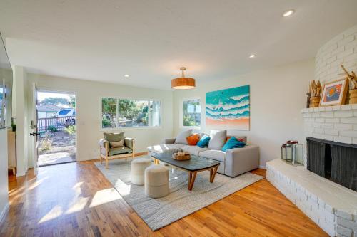 a living room with a couch and a fireplace at Seaside Home with Hot Tub and Patio Close to Beaches! in Seaside