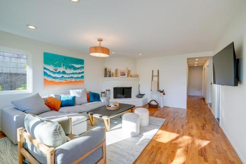 a living room with a couch and a fireplace at Seaside Home with Hot Tub and Patio Close to Beaches! in Seaside