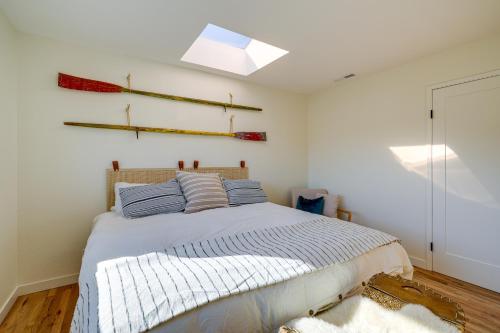 a bedroom with a bed with blue pillows and a window at Seaside Home with Hot Tub and Patio Close to Beaches! in Seaside