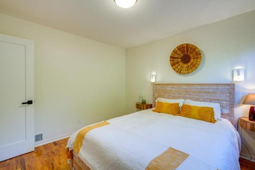 a bedroom with a large white bed with yellow pillows at Seaside Home with Hot Tub and Patio Close to Beaches! in Seaside