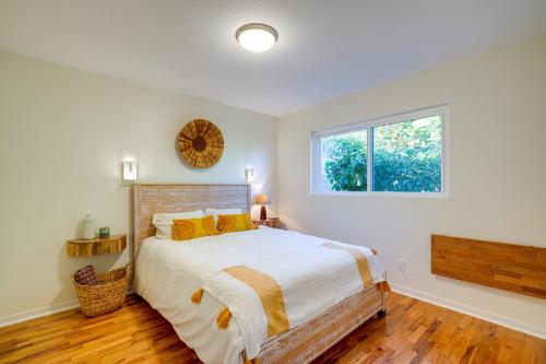 a bedroom with a large bed and a window at Seaside Home with Hot Tub and Patio Close to Beaches! in Seaside