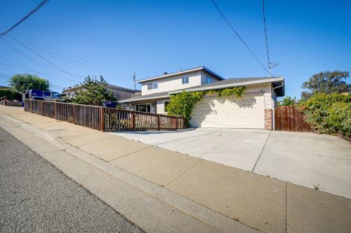 a white house with a fence and a driveway at Seaside Home with Hot Tub and Patio Close to Beaches! in Seaside