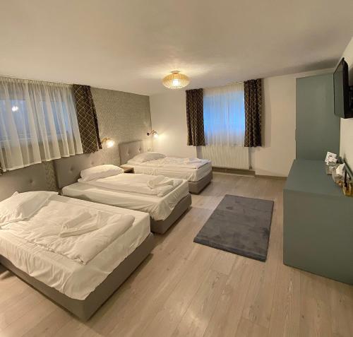 a bedroom with two beds and a television in it at Adi&Nicol in Sibiu