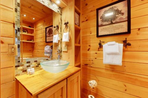 a bathroom with a sink in a log cabin at A Finger Lakes Favorite in Prattsburg