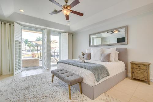 a bedroom with a bed and a ceiling fan at Lighthouse Point Home with Pool and Canal Access in Lighthouse Point