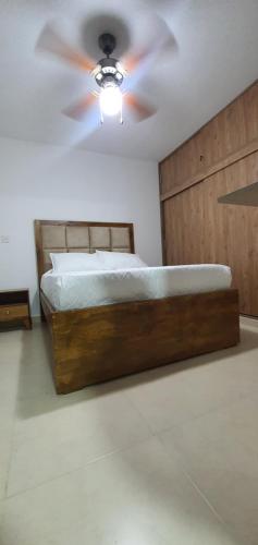 sypialnia z łóżkiem i wentylatorem sufitowym w obiekcie ApartaSol Reserva de la Colina w mieście La Tebaida