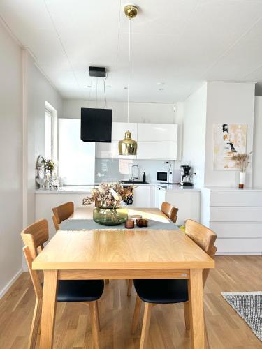 a kitchen and dining room with a table and chairs at 46m2 Studio in Rovaniemi