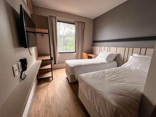 Un ou plusieurs lits dans un hébergement de l'établissement Plaza Hotel & Boulevard Convention - Vale dos Vinhedos