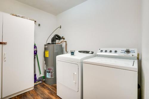 a kitchen with a stove and a washer and dryer at Family-Friendly Peoria Retreat with Private Pool! in Peoria