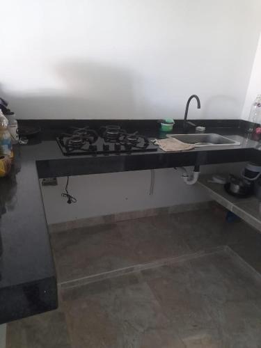a kitchen counter with a stove and a sink at comfortable accommodation in Villa del Rosario