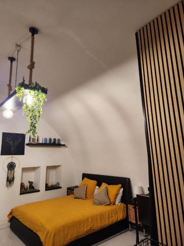 a bedroom with a bed with a yellow blanket at Le Volte B&B in Sammichele di Bari