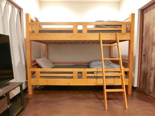 a bunk bed with a ladder in a room at futaba heights - Vacation STAY 15533 in Tokyo