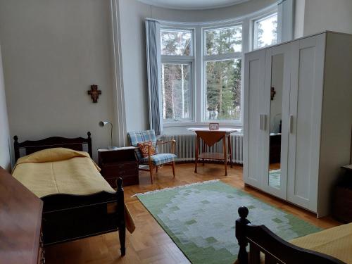 a bedroom with a bed and a large window at Birgittagården in Falun