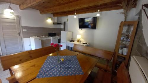a room with a wooden table with a vase of flowers on it at Pod Wodospadem in Szczyrk