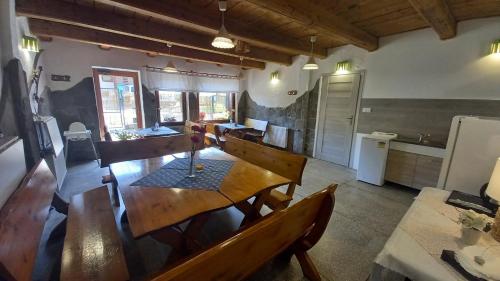 a dining room with a table and a kitchen at Pod Wodospadem in Szczyrk