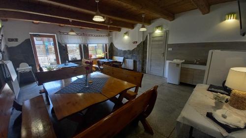 a kitchen with a wooden table and a dining room at Pod Wodospadem in Szczyrk