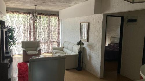 Casa en San Luis في لا فلوريستا: غرفة معيشة مع أريكة وكرسي