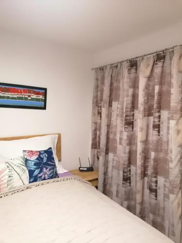 a bedroom with a bed and a curtain at Studio Duch in Český Krumlov