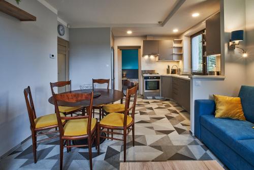 a living room with a table and chairs and a blue couch at Apartmán u Martina in Jablonec nad Nisou