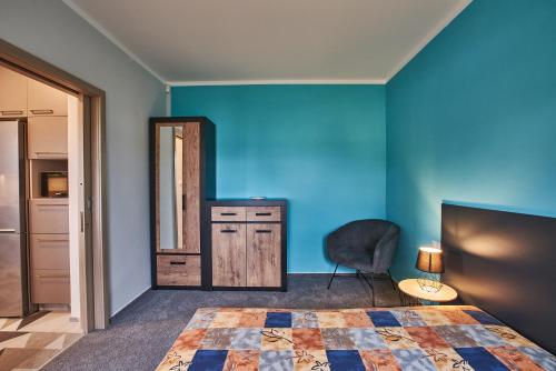 a bedroom with a bed and a mirror and a chair at Apartmán u Martina in Jablonec nad Nisou
