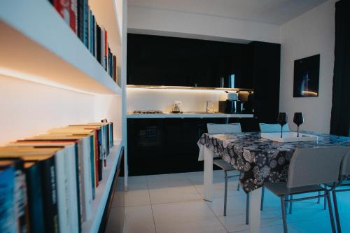 a dining room with a table and some books at Principato di Baragallo - Free Private Parking in Sanremo