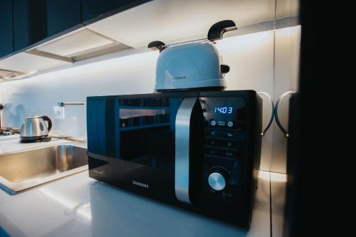 a microwave sitting on a counter in a kitchen at Principato di Baragallo - Free Private Parking in Sanremo