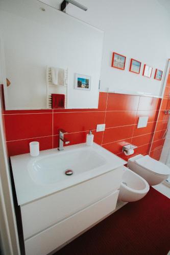 a bathroom with a white sink and a toilet at Principato di Baragallo - Free Private Parking in Sanremo