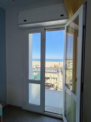 an open door with a view of a balcony at Hotel Ariston Imperial in Porto Garibaldi