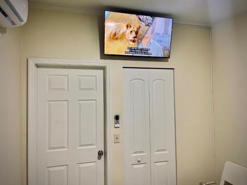 a flat screen tv on a wall above a door at Private Room near Miami Airport - Free parking - 01 in Miami