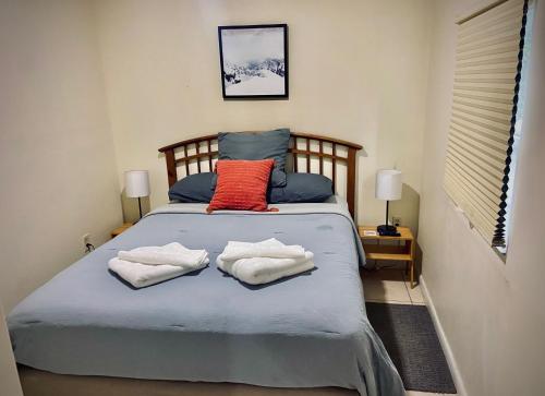 a bedroom with a bed with two towels on it at Private Room near Miami Airport - Free parking - 01 in Miami