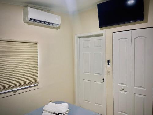 a room with a window and a air conditioner on the wall at Private Room near Miami Airport - Free parking - 01 in Miami