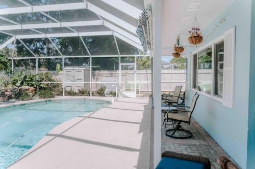une terrasse avec une piscine et une maison dans l'établissement Entire home, heated pool, just 10 min to beach!, à Vero Beach