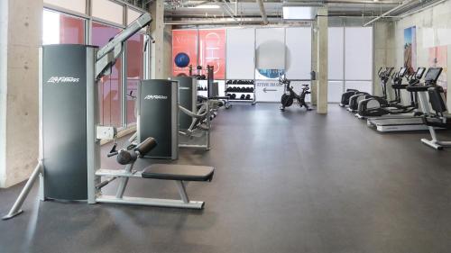 a gym with several treadmills and cardio machines at CH Luxury Condos & Studios On The Beach in Hollywood
