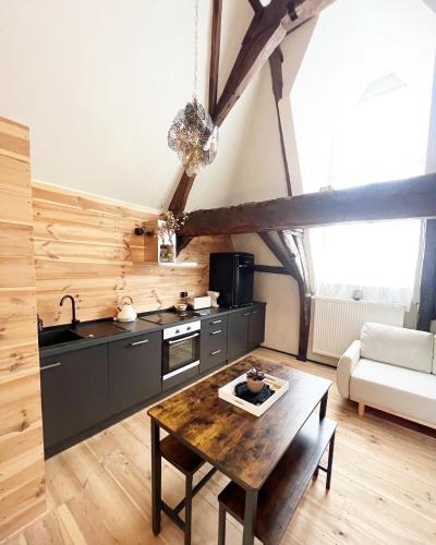 a kitchen with a table in the middle of a room at LouLou Home's in Antwerp