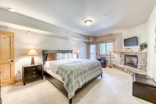 a bedroom with a bed and a fireplace at #304 Grand Lodge South in Government Camp