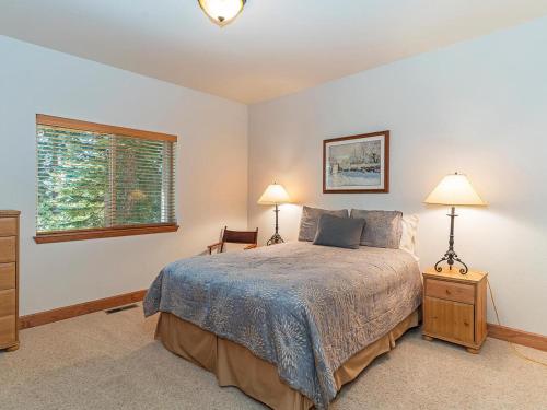 a bedroom with a bed and two lamps and a window at Amazing mountain setting in Incline Village