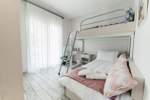 a bedroom with a bunk bed with a ladder at Onar Village Luxury Apartments in Kavala