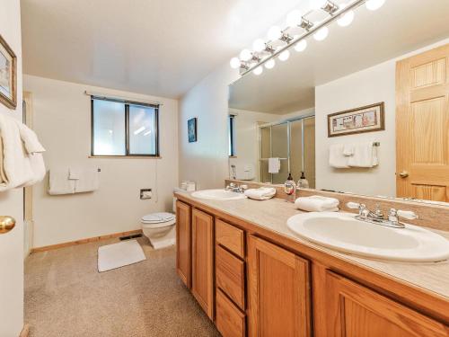 a bathroom with a sink and a toilet and a mirror at Perfect location walk to town and nature in Incline Village