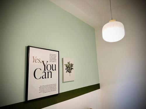 a room with a picture and a light fixture at Urban Suite Cozy Family Homestay at Georgetown by URBAN STAYCATION HENG LOD in Jelutong