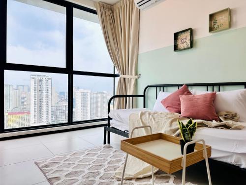 a living room with a bed and a large window at Urban Suite Cozy Family Homestay at Georgetown by URBAN STAYCATION HENG LOD in Jelutong
