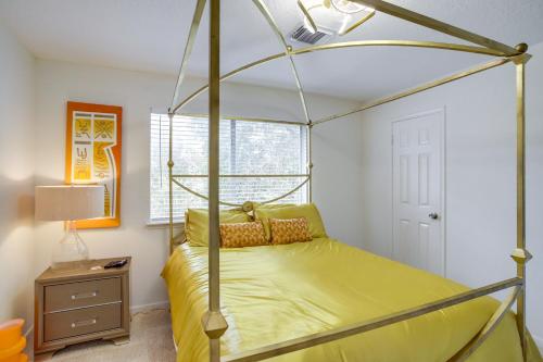 a bedroom with a canopy bed with yellow sheets at Spacious Houston Home with Patio, Grill and Fireplace! in Houston