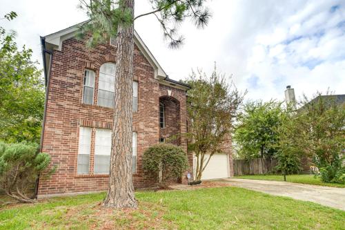 a brick house with a tree in the yard at Spacious Houston Home with Patio, Grill and Fireplace! in Houston