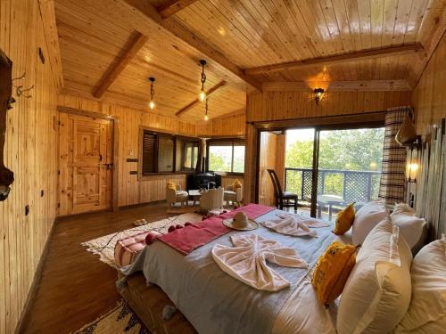 a bedroom with a large bed in a wooden room at Riad Jnane Imlil in Imlil