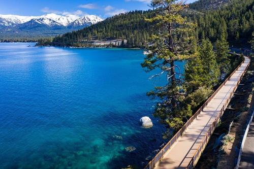 an aerial view of a lake with trees and a dock at Incredible Lake Tahoe Views 2 Master Suites and a Loft in Incline Village