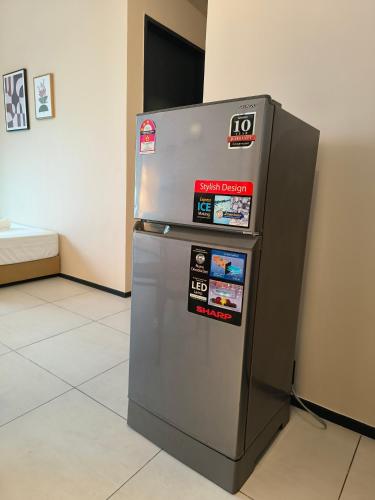 a refrigerator with many magnets in a room at Urban Suite Cozy Family Homestay at Georgetown by URBAN STAYCATION HENG LOD in Jelutong