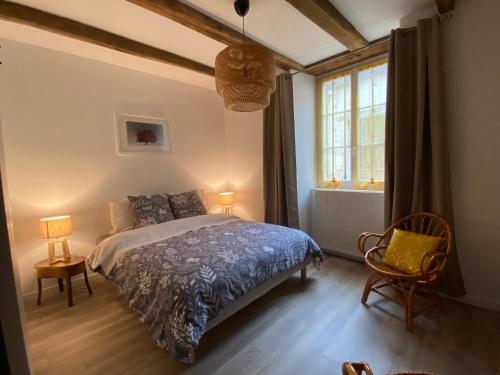 a bedroom with a bed and a window at Chez Odette chambre saule pleureur in Esnoms-au-Val