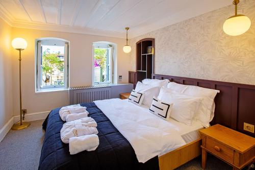 a bedroom with a large bed with towels on it at Mansion Miliá in Adalar